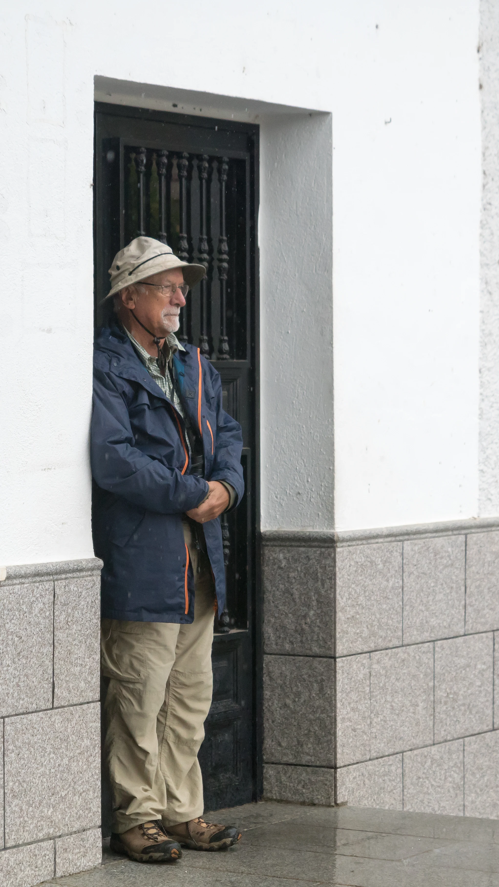 Mike sheltering from the rain, Santa Marta de Magasca, Extremadura, Spain — photo by Jim Bennett
