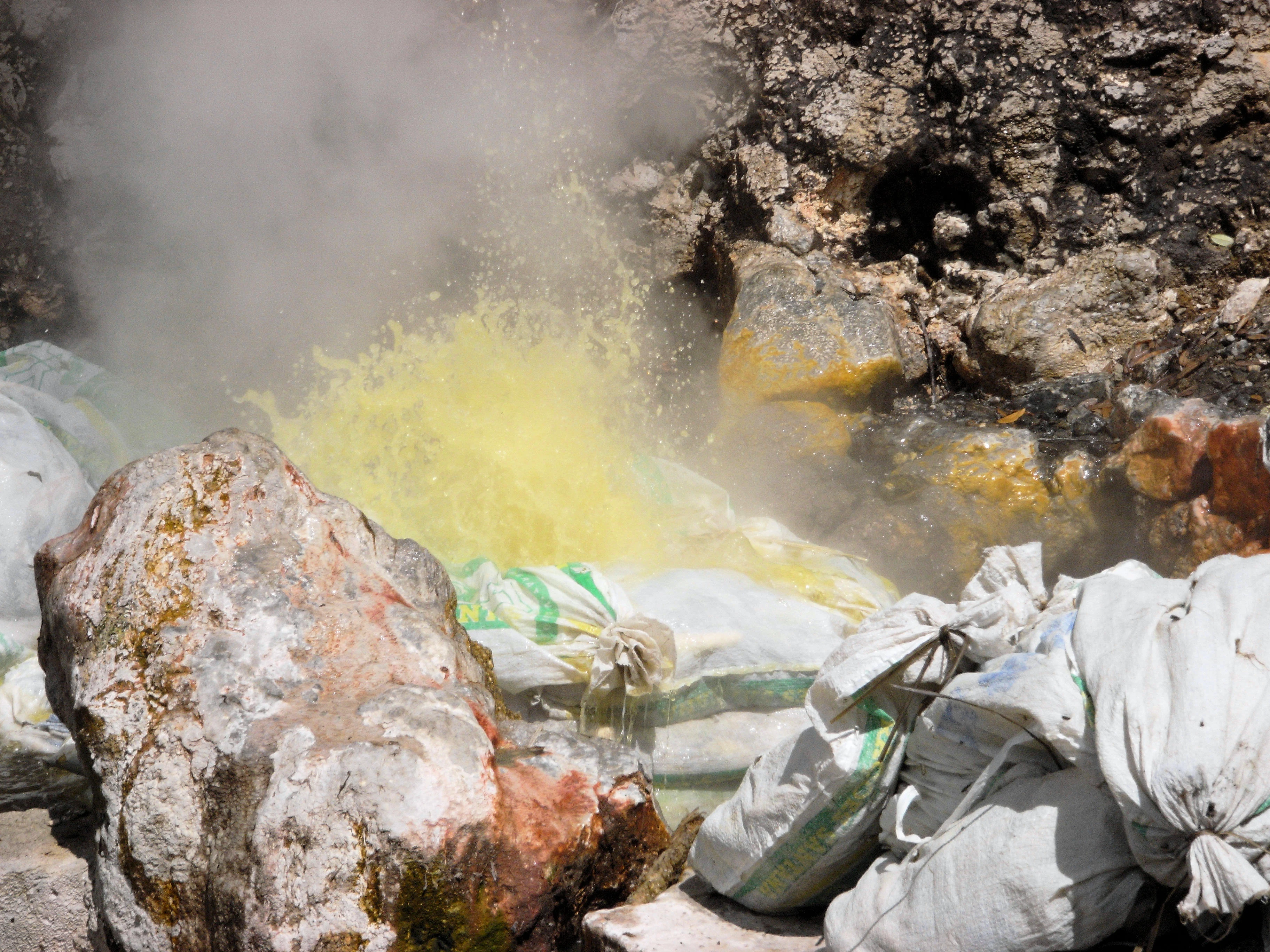Cooking sacks of sweetcorn in a hot spring, Furnas, Azores, Portugal — photo by Jim Bennett