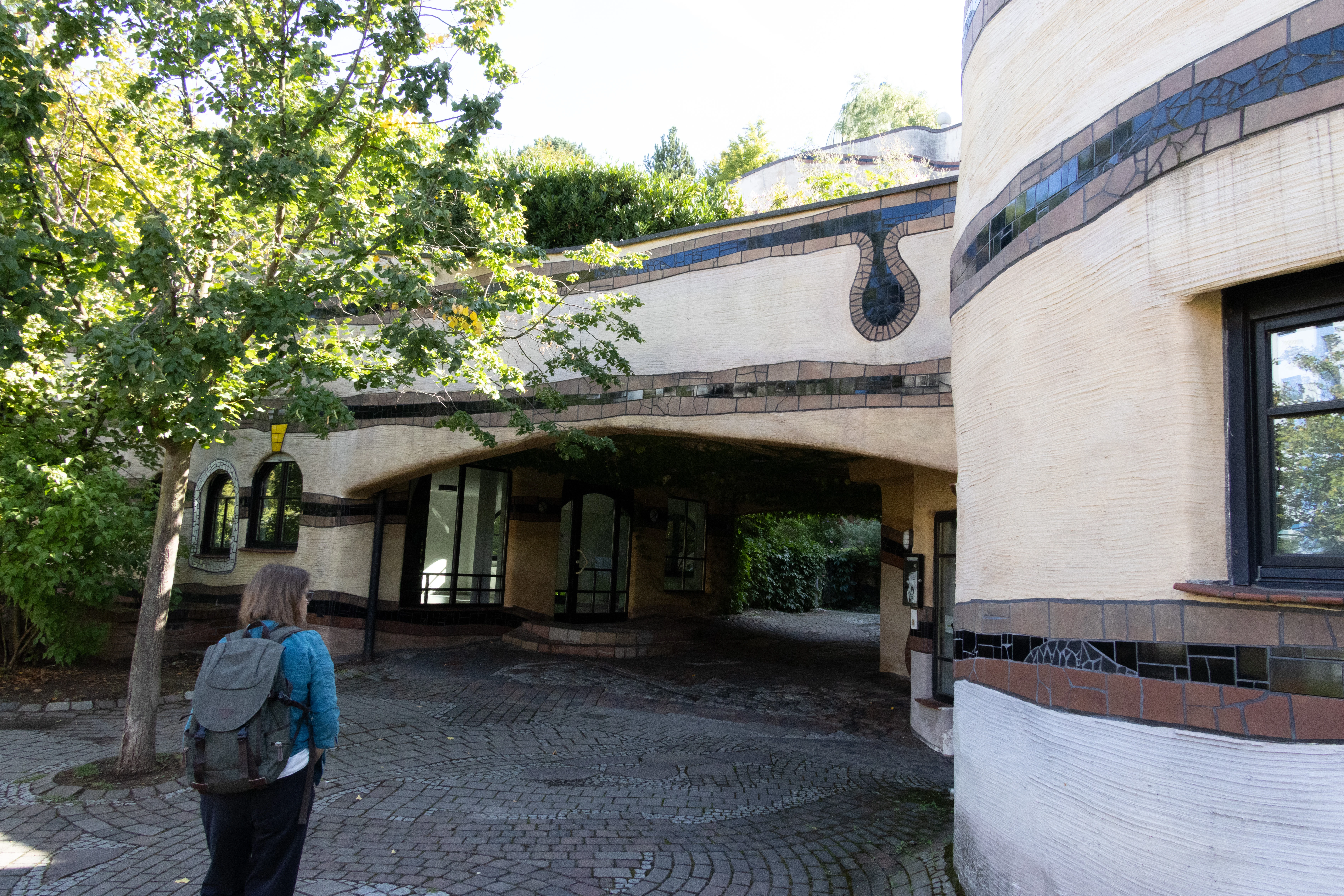 Doris with backpack near Hundertwasser building, Darmstadt, Germany — photo by Adam Prugel-Bennett
