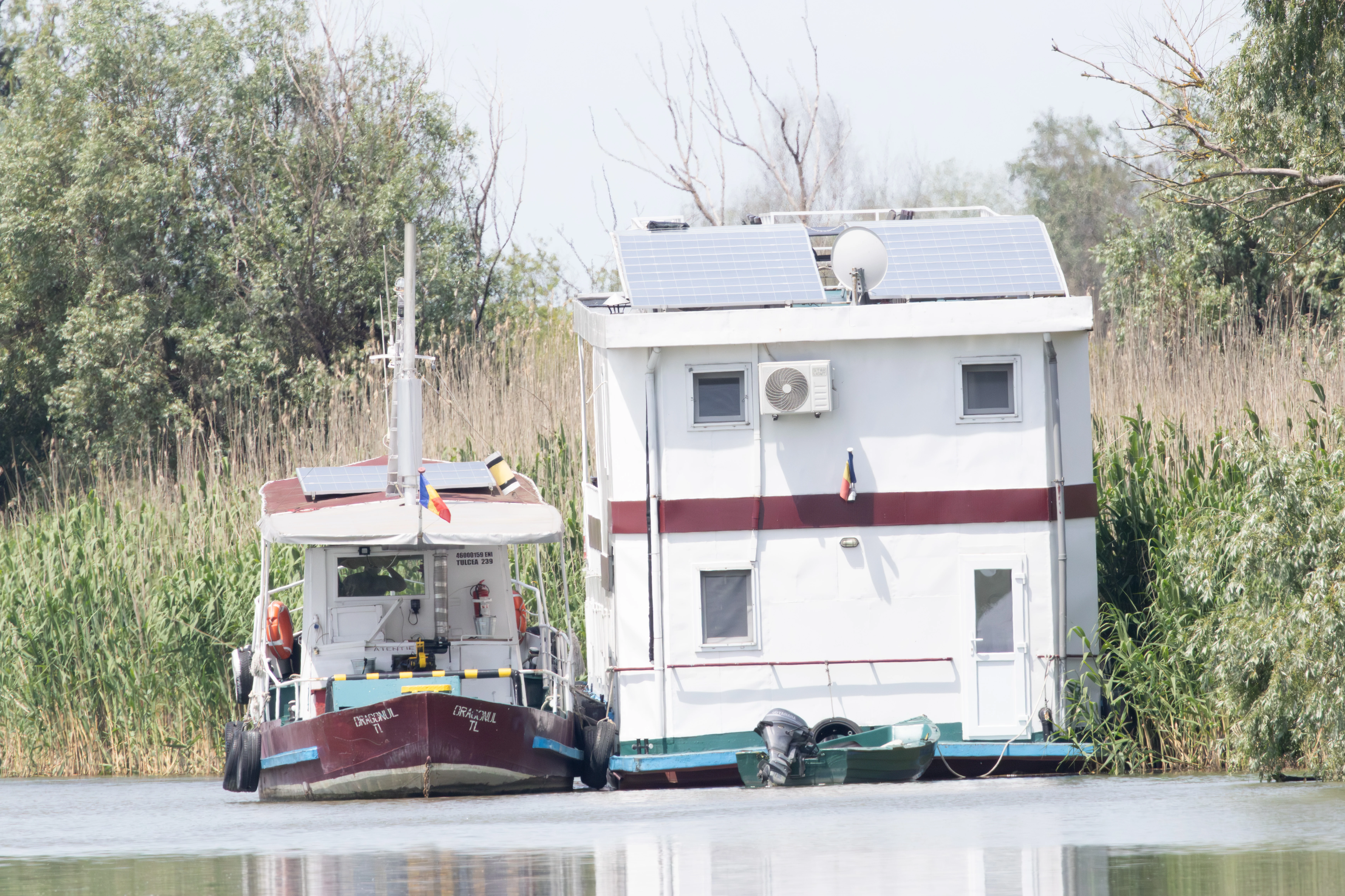 Houseboat and small boat in Danube delta, Danube Delta, Romania — photo by Adam Prugel-Bennett